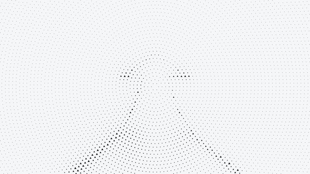 Halftone dots forming a triangular pattern on a white surface