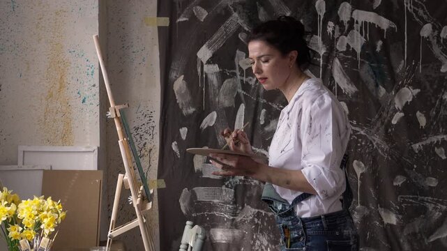 woman artist drawing and dancing at art studio