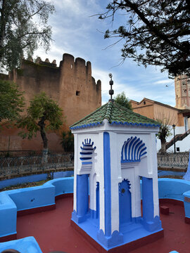 Traditional blue and white Moroccan architecture in Chefchaouen Morocco with historic fortress background, colorful Islamic design in famous blue city, cultural landmark and North Africa travel