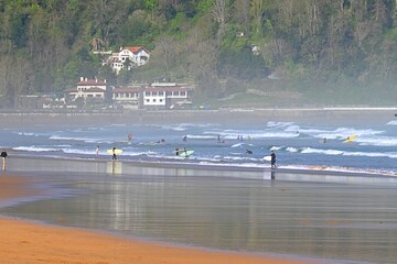 Capturing the spirit of the ocean, this image shows surfers riding the waves near Zarautz, Guipúzcoa, Basque Country, one of the most popular surfing spots in Spain. © GenadiyGM
