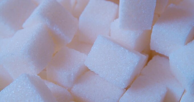 A  sugar cubes filmed in gentle, indirect daylight. Food background. The soft natural light. Closeup shot.