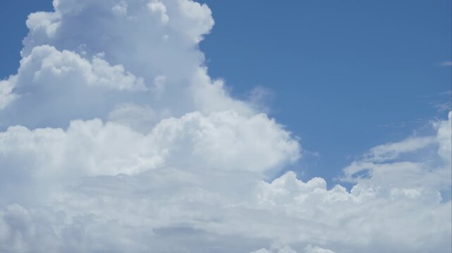 White Cumulus Clouds Moving Across Blue Sky