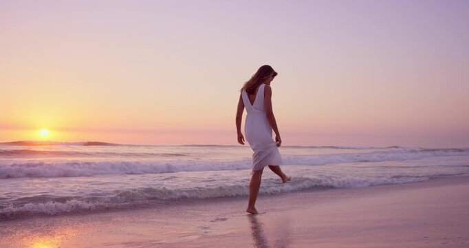 Travel, walk or woman at beach with thinking, sunset or peaceful mindset on seaside vacation. Stroll, wave splash or tourist at ocean with getaway, calm perspective or summer evening on holiday break