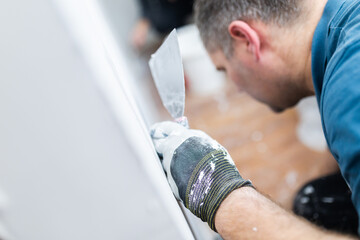Naklejka premium Close-Up of Worker Holding Plaster and Trowel
