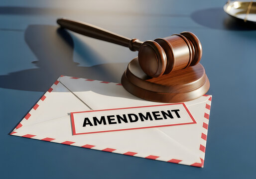 Wooden judge gavel resting on a white envelope with the word amendment printed on it for legal and justice concepts