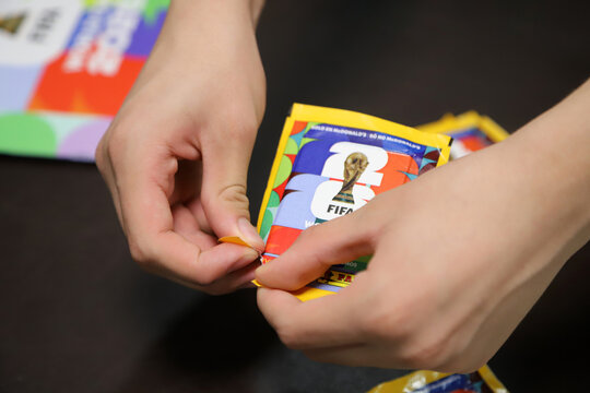 
Person opening a pack of stickers for the 2026 FIFA World Cup. Panini sticker pack in collaboration with McDonald's