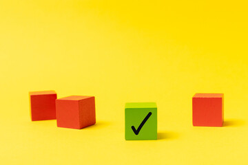 Stacked wooden cubes with check marks on background. Tick mark on check boxes. Checklist concept, tick on wooden blocks. Space for text.Space for text. Flat Lay © Avocado_studio