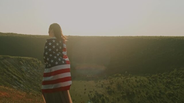Lady With Flag. An Elegant Woman Standing Draped In United States Flag During Tranquil Sunrise Scene