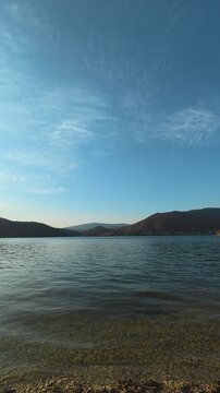 Sunlight glimmers softly on the gentle ripples.  Bovan lake. Balkans, Serbia.