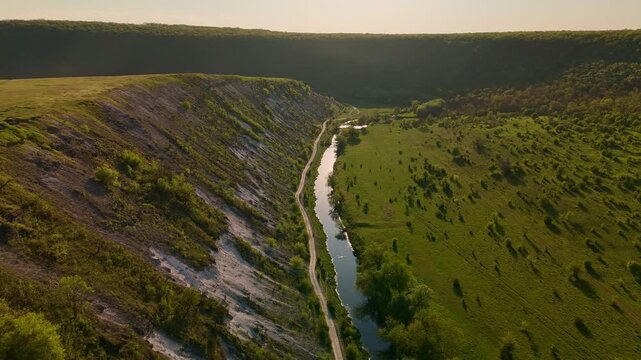 Aerial View Of Winding River Through Green Canyon, Steep Chalk Cliffs, Narrow Watercourse, Serene Landscape