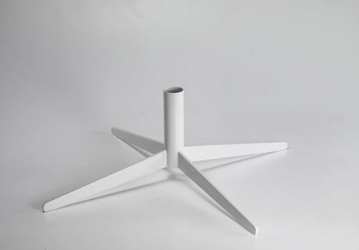 Still life of the iron base of a table, on a neutral background