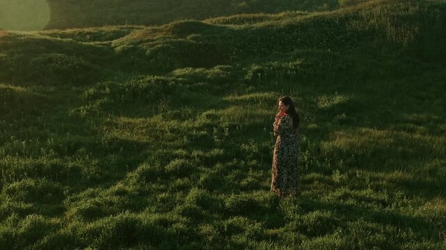 Woman Walking Through Grassy Dunes In Late Afternoon, Contemplative Profile Shot, Flowing Dress And Soft