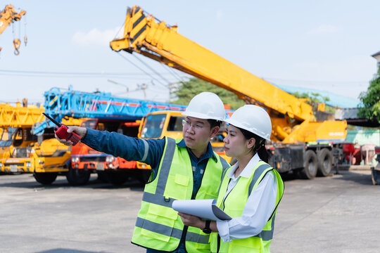 Engineers coordinate crane inspection with radio and checklist in a heavy equipment yard, emphasizing safety, lifting readiness, and maintenance control at worksite.