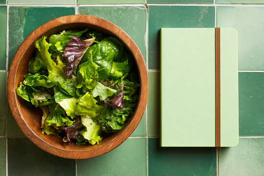A Green Salad in a Wooden Bowl, Green Notebook, Green Tile, Fresh Healthy Eating 