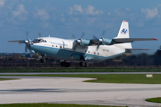 Luqa, Malta - December 24, 2005: Aerovis Airlines Antonov An-12AP (REG: UR-CCP), the "Russian Hercules", takes off from runway 32. 