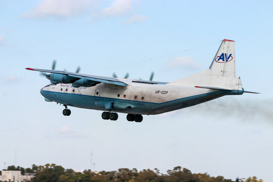 Luqa, Malta - December 24, 2005: Aerovis Airlines Antonov An-12AP (REG: UR-CCP), the "Russian Hercules", takes off from runway 32. 
