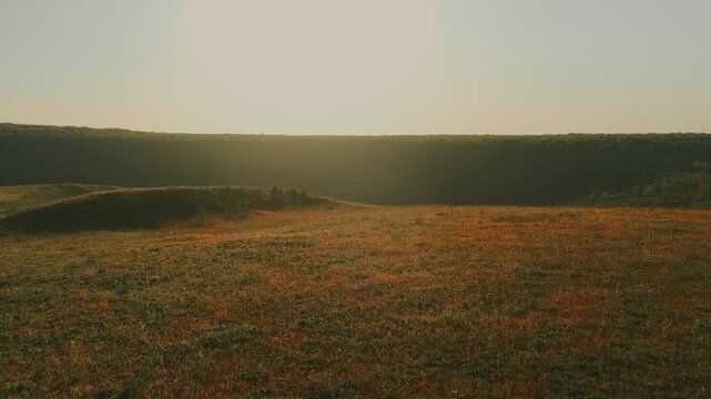 Expansive Golden Prairie At Sunset With Rolling Hills, Warm Backlight, Textured Grasses, Calm Horizon And Soft