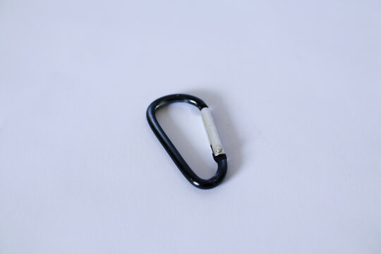 Black metallic carabiner clip isolated on white background