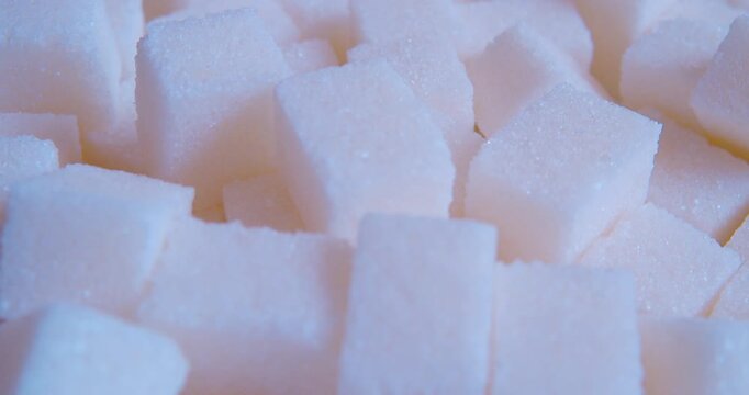 A macro shot of a pile of sugar cubes.Food background. The soft natural light.