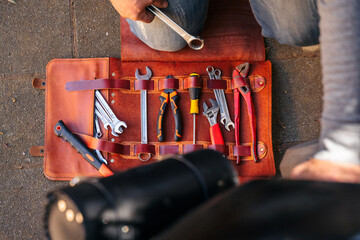 Top view motorcycle repair tools and wrench in hand © Bohdan