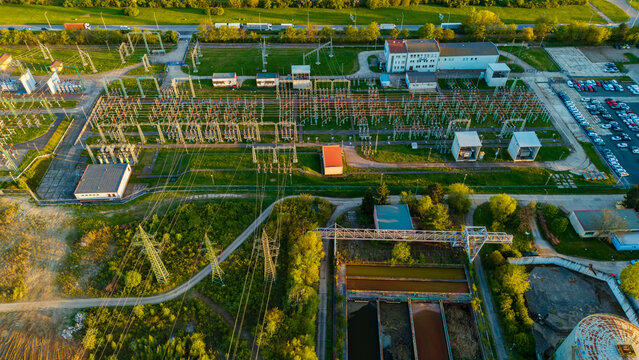 Aerial view of Malesice Infrastructure Objects with electrical substation, power lines, and industrial buildings under golden hour light Hlavni mesto Praha, Hlavni mesto Praha, Czechia.