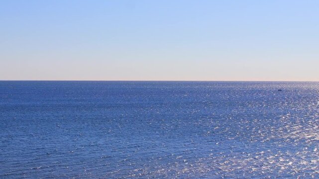 Morning Calm Sea with Fishing Boat and Fishermen, Clear Sky Ocean Background Video. Copy space.