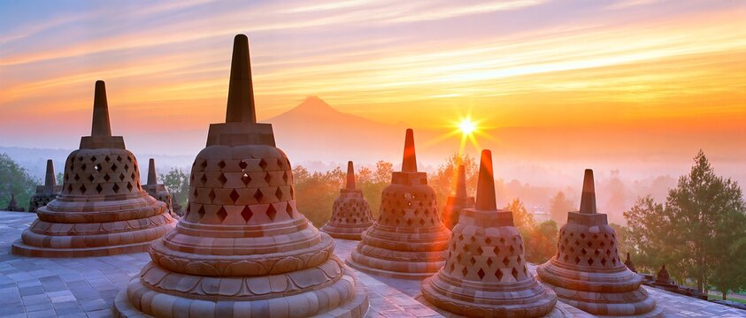 Sunset bathes ancient stupas in golden light