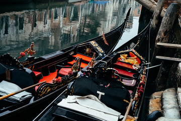 venetian gondolas in a row with the traditional ferro at front side © jon_chica