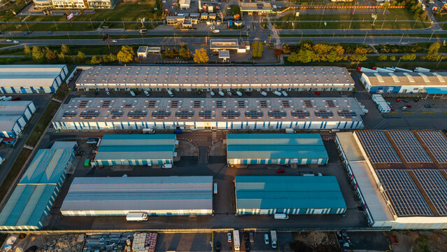 Aerial view of Malesice Infrastructure Objects showing industrial warehouses with solar panels on roofs and trucks at the logistics hub Hlavni mesto Praha, Hlavni mesto Praha, Czechia.