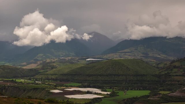 Time lapse of clouds forming over Imbabura Volcano, viewed from near Ibarra, Ecuador. Greenhouses for flower cultivation in foreground