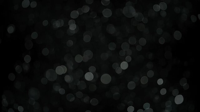 Bubbles floating in dark liquid with soft backlight creating abstract texture