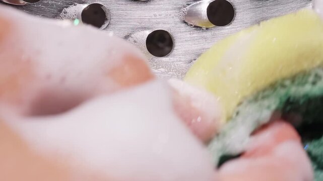 Sponge Scrubbing Metal Grater Surface with Soap Foam, Macro Top View Slider Shot, Slow Motion Cleaning Concept and Stain Removal Action