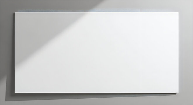Large white rectangle board on gray wall with shadow  empty space for text