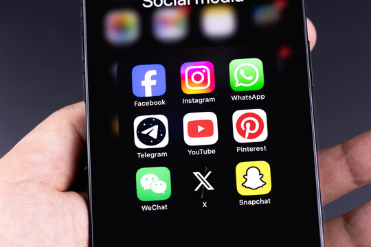 human hand holds smartphone with mobile social media apps Facebook, Instagram, Telegram, WhatsApp, YouTube, Pinterest, X, Snapchat. Batumi, Georgia - March 16, 2026