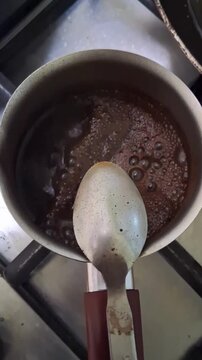 Turkish Coffee Brewing in Steel Cezve Pot on Gas Stove