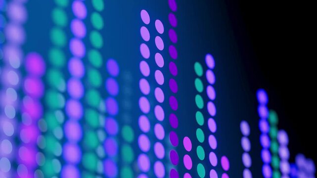Colorful light display showing sound wave patterns on a screen in a digital art setting during a night event.