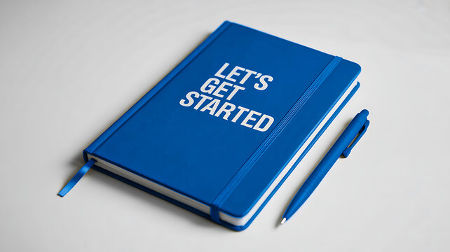 Blue notebook with lets get started text and pen on minimal background
