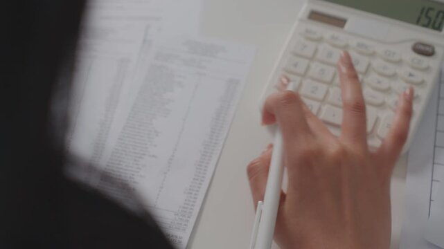 Expenses finance credit. Credit cost budget. writing on a bills and using a calculator. Accountant, hands with calculator, paid bills. audit for economic market, tax assessment planning.