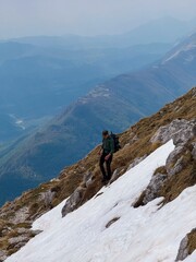 Fototapeta premium Trekking Through Spring Mountains with Snow