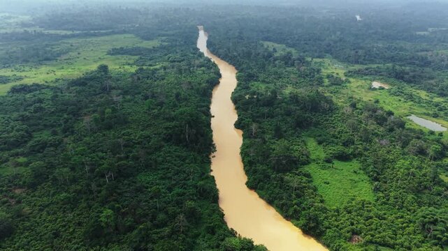 River heavily polluted brown with sediment from illegal galamsey gold mining operations in Ghana