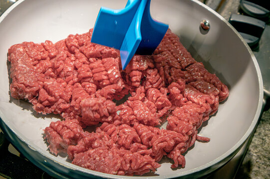 Ground beef cooking in a pan