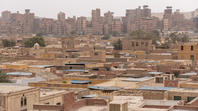Cairo's city of the dead featuring a dense urban landscape, traditional housing, and modern buildings depicting socioeconomic stratification