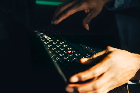 Close-up of businessman working on laptop at modern startup office