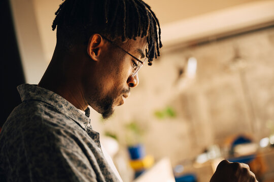 Side view of businessman with dreads at office
