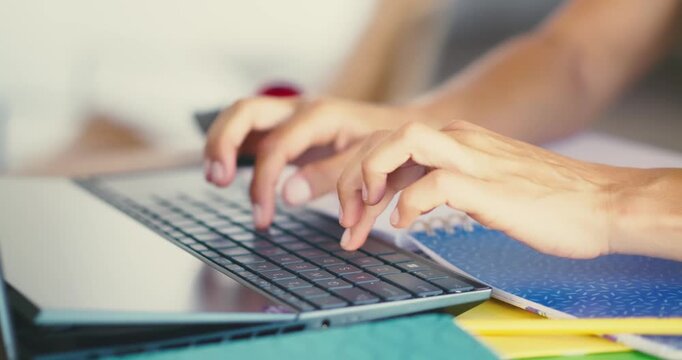 Hands Typing on Laptop in Office Environment