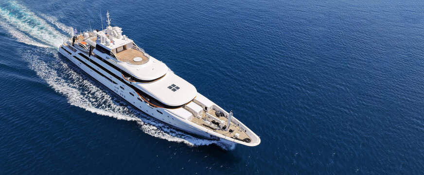 Aerial drone ultra wide panoramic photo with copy space of luxury yacht with wooden deck cruising near port Port Hercules in deep blue sea, Monaco, France