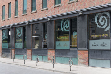 Naklejka premium exterior building and signage in window at Grace O’Malley’s, an Irish pub, located at the corner of 14 Duncan St and Pearl St, Toronto
