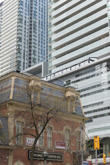 Naklejka premium exterior of historic building (William Barber Building, 1880) and sign of Second Cup Café, 289 King St W, Toronto