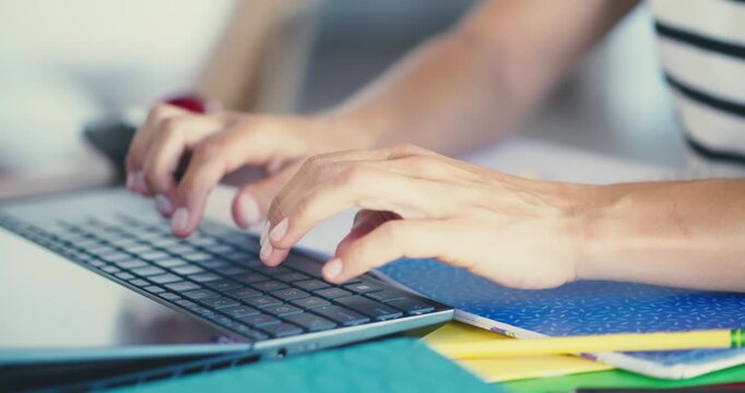 Person Typing on Laptop in Office Setting