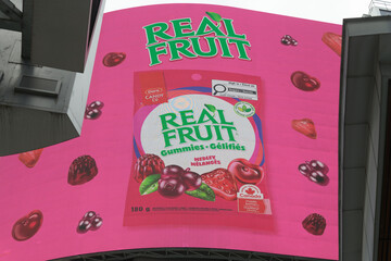 Naklejka premium digital billboard featuring ad for RealFruit Gummies by Dare Foods Limited at Sankofa Square, Toronto